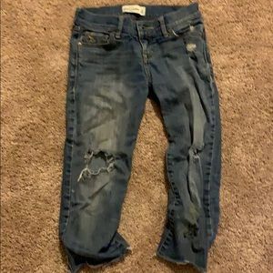 Pair of below knee ripped jeans